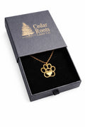 Gold dog paw print necklace in a Cedar Roots gift box