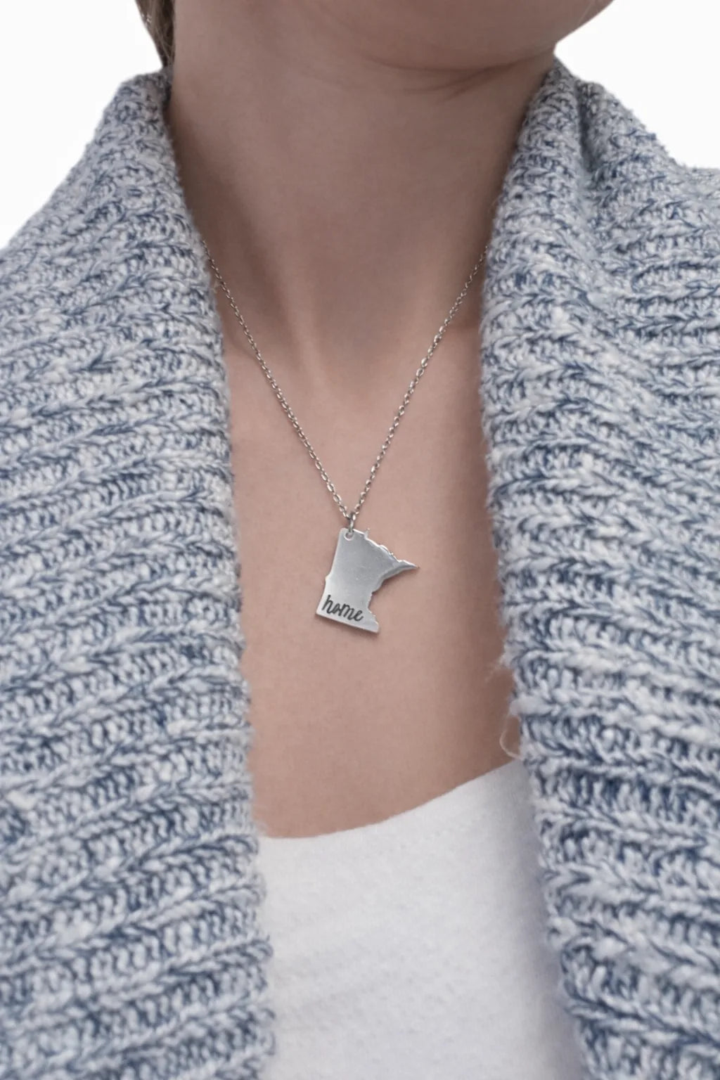 Woman wearing a silver Minnesota state pendant necklace